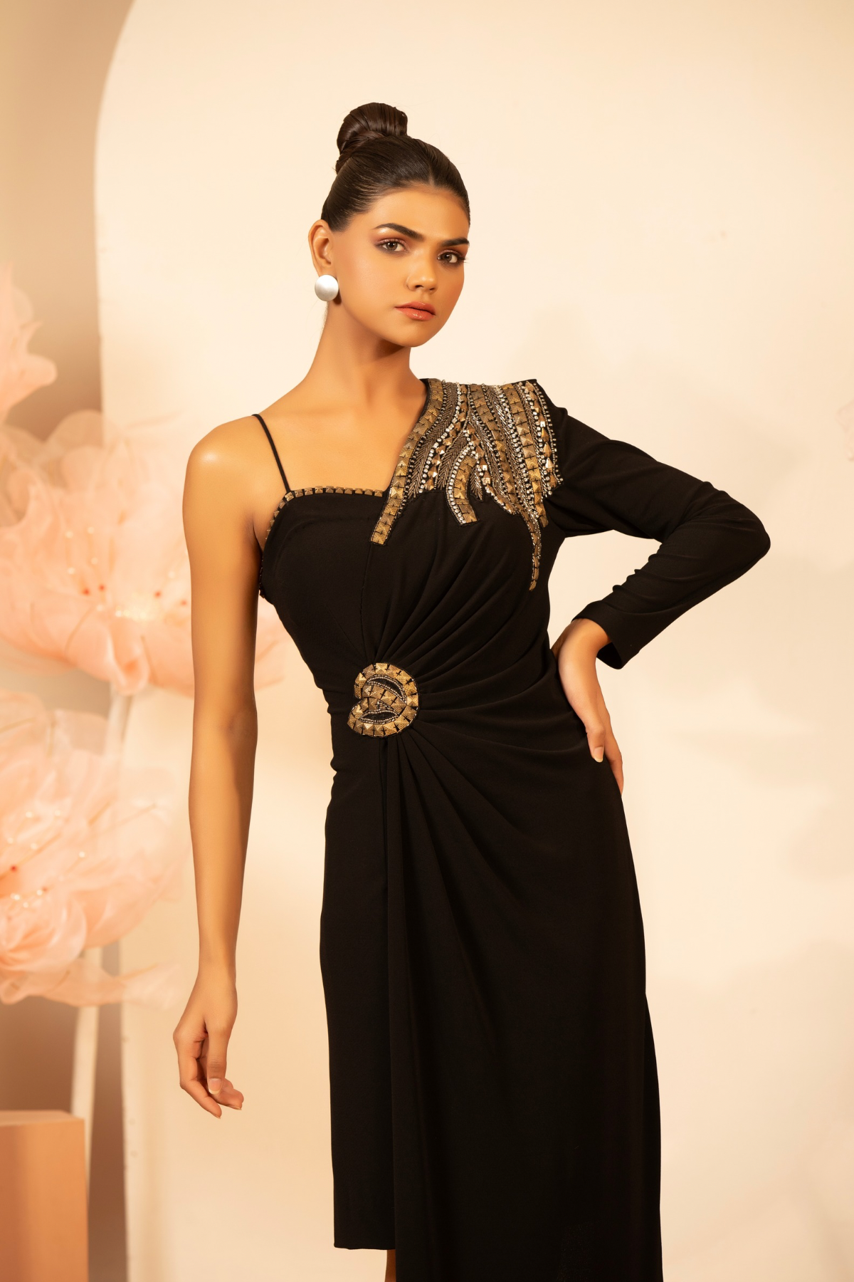 This elegant asymmetrical one shoulder draped silhouette a thin noodle strap on the right and a full sleeve on the left embellishment wings like patterncrafted with silver crystal metallic sequins and high contrast structural draping Shop Now!