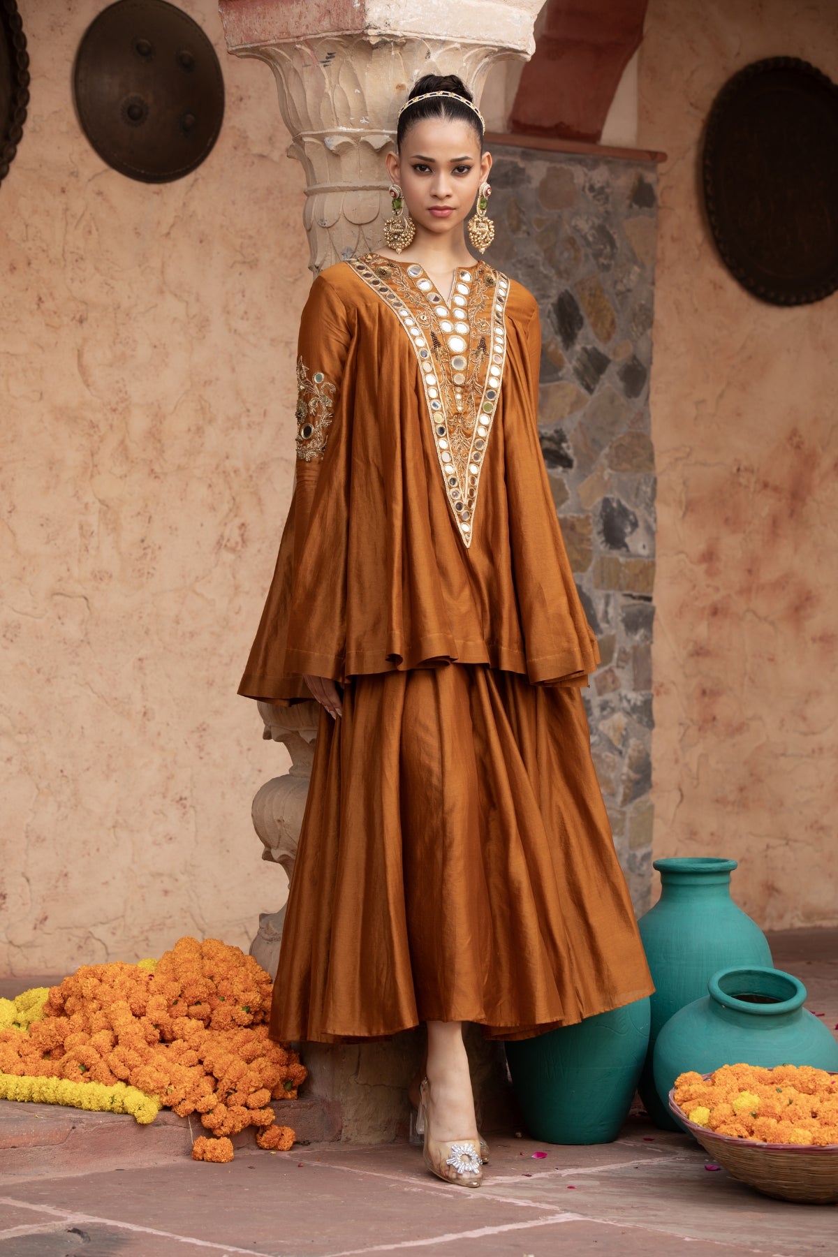 ure Chanderi silk kalidaar tunic with midi lehenga, intricately hand-embellished with zari and mirror work. Shop Now!