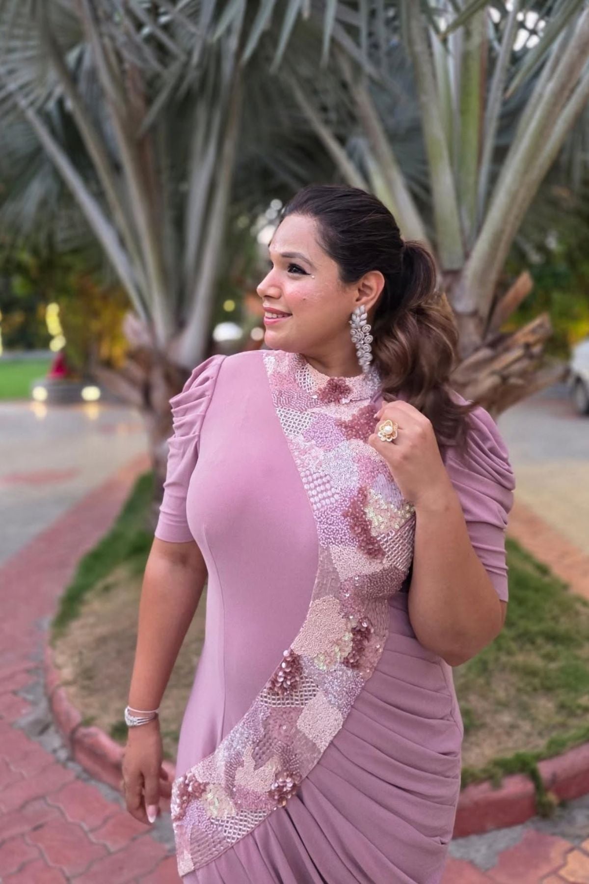 The dress is designed with a flattering form fitting bodycon include soft draping slightly stretchyhigh neck collar and structured puff sleeves shimmering multi tone sequins that flow from neckline to down across. Shop Now!