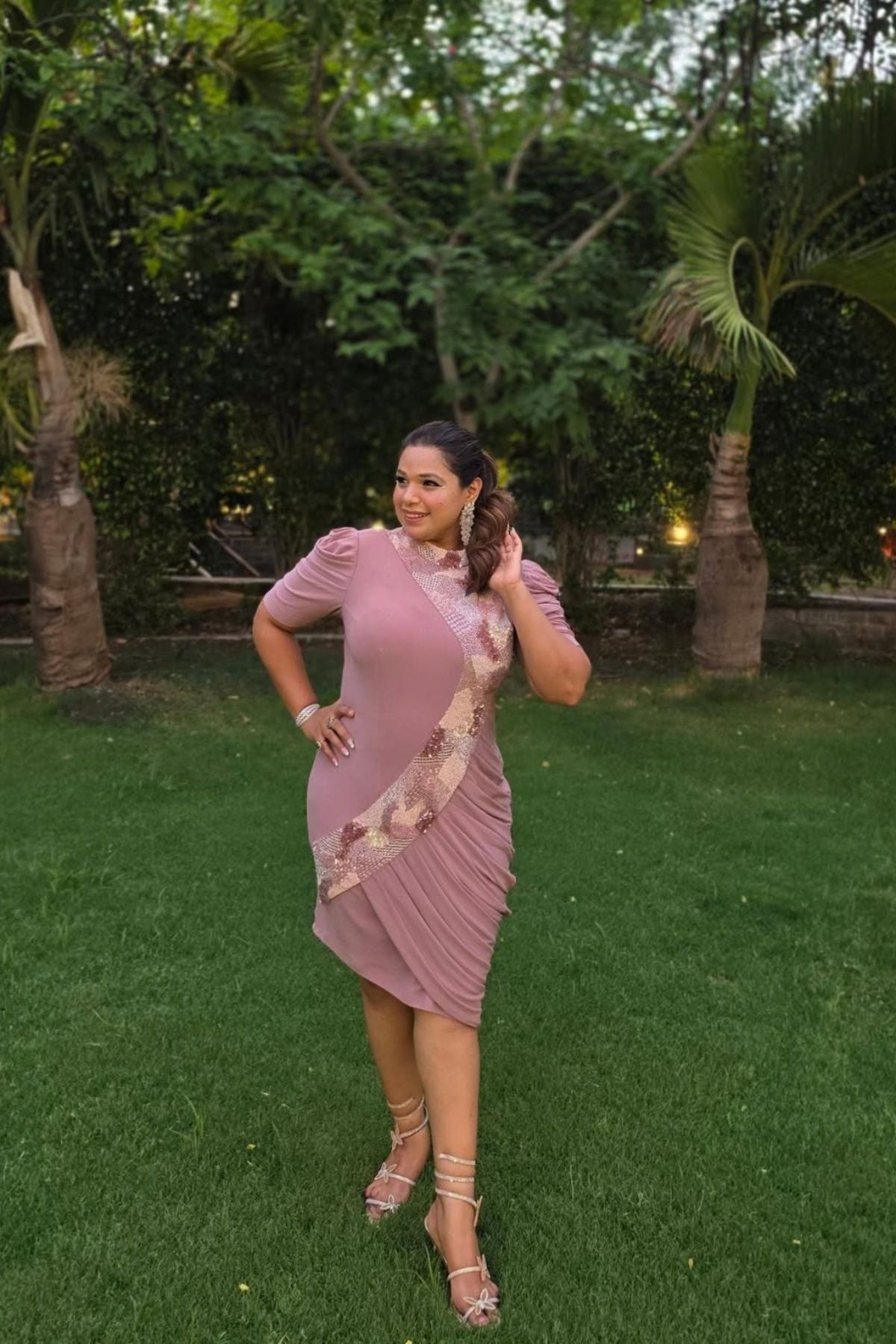 The dress is designed with a flattering form fitting bodycon include soft draping slightly stretchyhigh neck collar and structured puff sleeves shimmering multi tone sequins that flow from neckline to down across. Shop Now!