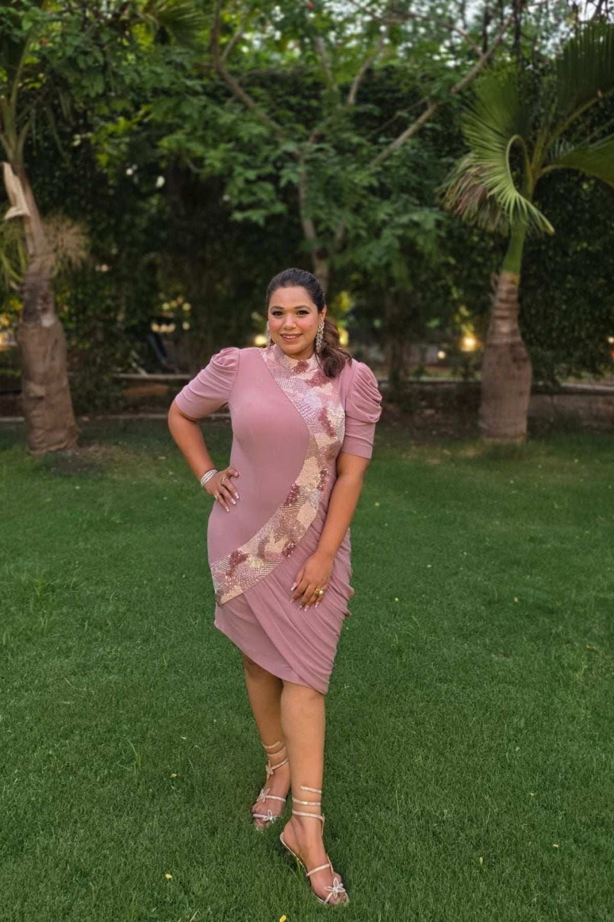 The dress is designed with a flattering form fitting bodycon include soft draping slightly stretchyhigh neck collar and structured puff sleeves shimmering multi tone sequins that flow from neckline to down across. Shop Now!