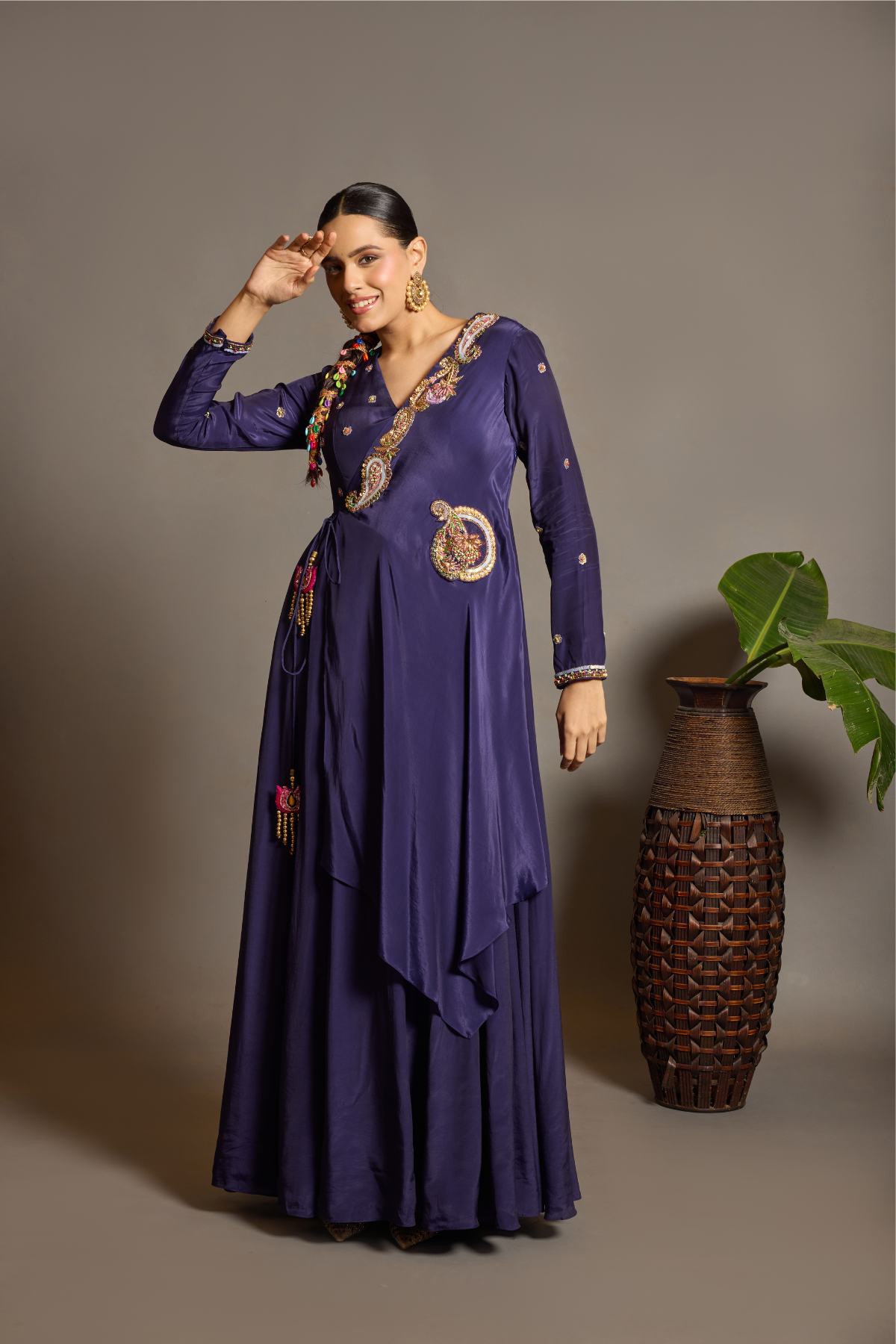A sophisticated festive deep purple Anarkali crafted in luxurious fluid fabric with a graceful layered flare. Intricate multicolour floral and paisley embroidered adds a rich artisanal touch.handcrafted statement tassels ,a flattering tie-up waist & delicate embellishment. Shop Now!
