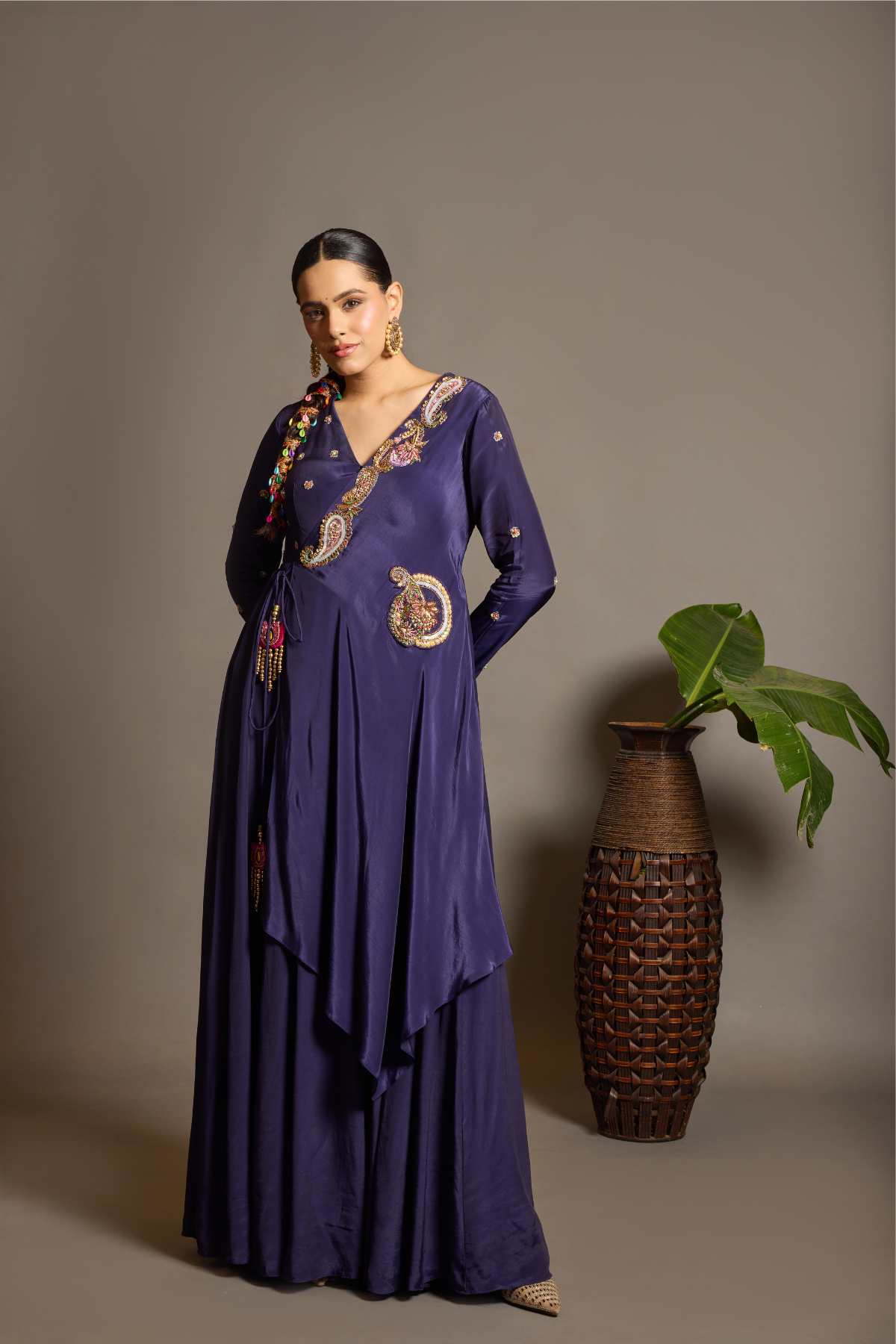 A sophisticated festive deep purple Anarkali crafted in luxurious fluid fabric with a graceful layered flare. Intricate multicolour floral and paisley embroidered adds a rich artisanal touch.handcrafted statement tassels ,a flattering tie-up waist & delicate embellishment. Shop Now!