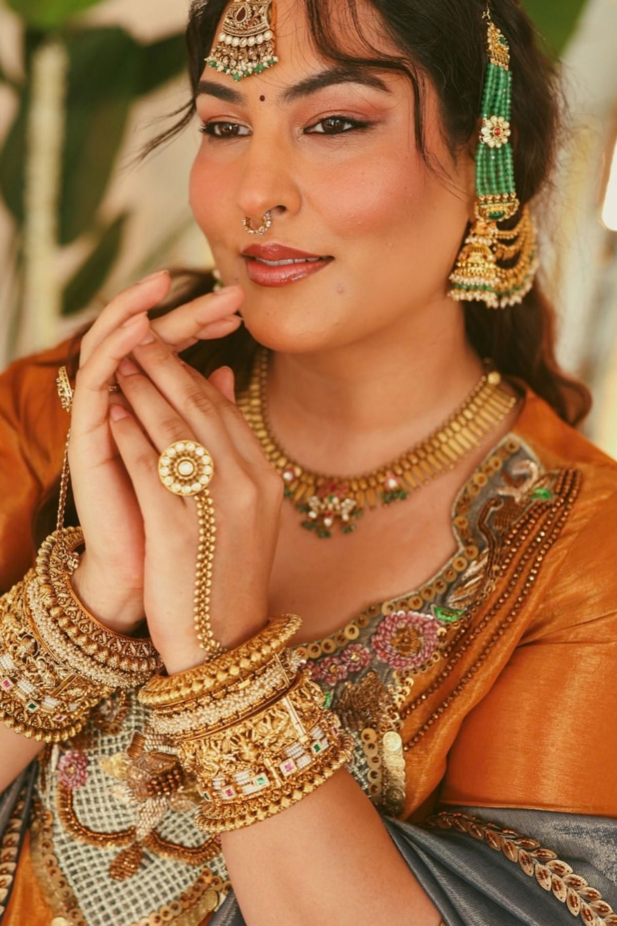 A luminous burnt-orange kurta in a rich metallic finish, elevated with an ornate handcrafted embroidered yoke. The statement neckline features intricate multicolour florals, paisleys,sequins and antique-gold detailing. Layered with a deep-navy blue metallic dupatta finished with ornate borders and delicate embellishment. A festive look that blends contemporary glamour with traditional Indian craftsmanship. Shop Now!