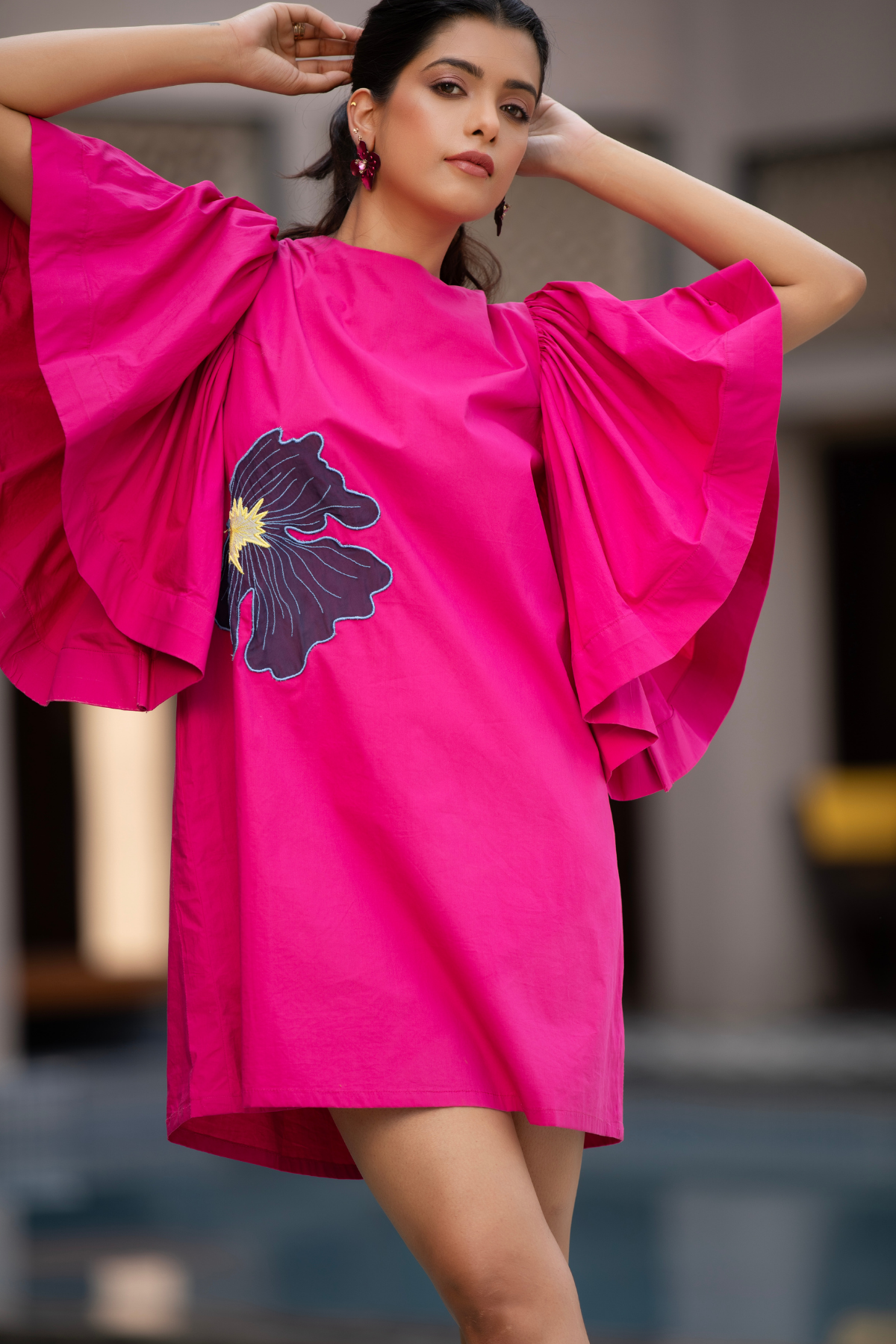 This vibrant fuchsia pink mini dress is characterized by its bold silhouette and striking artistic details Shop Now!