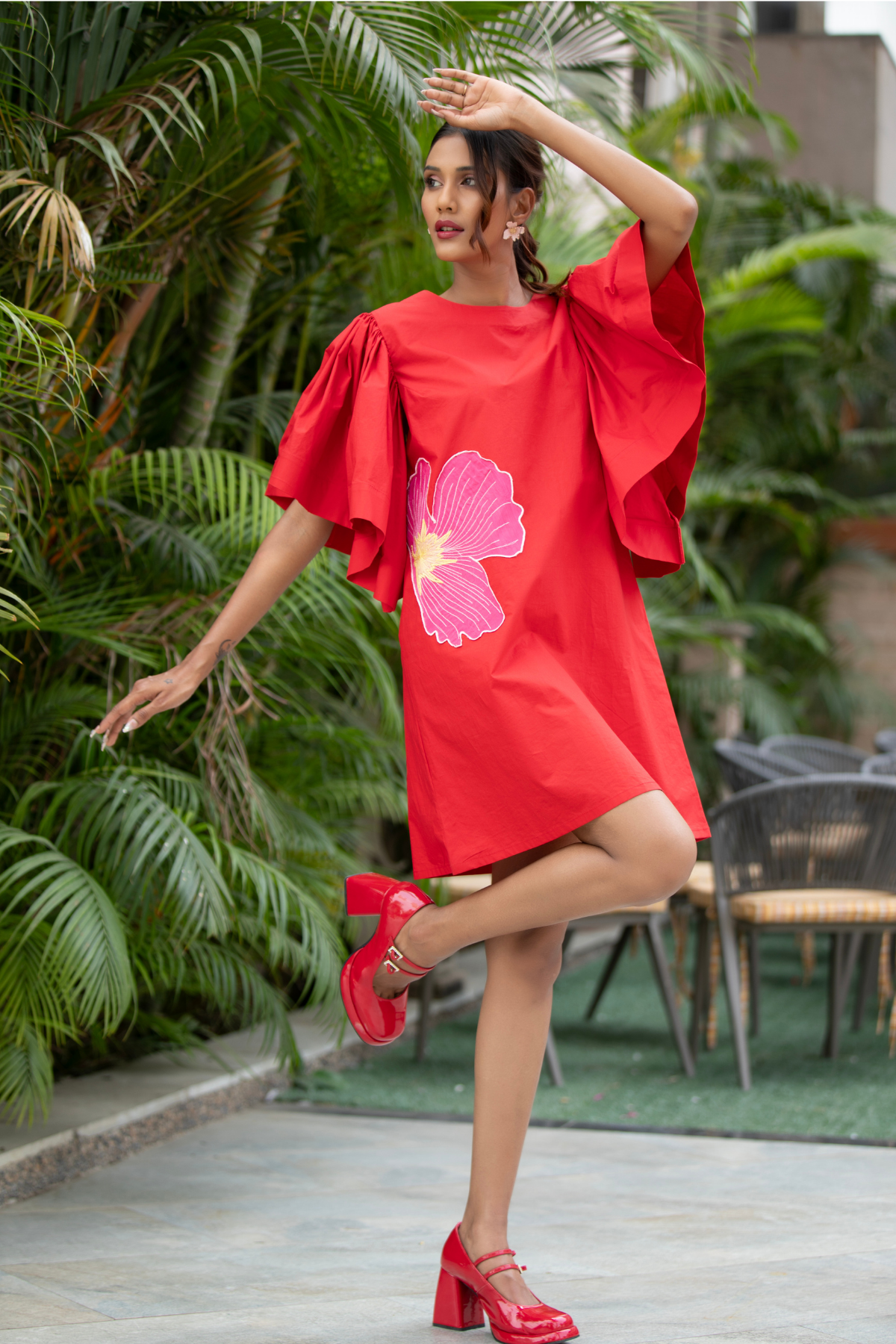 The dress is a vibrant red shift mini dress balance as relaxed fit and bold architectural details Shop Now!