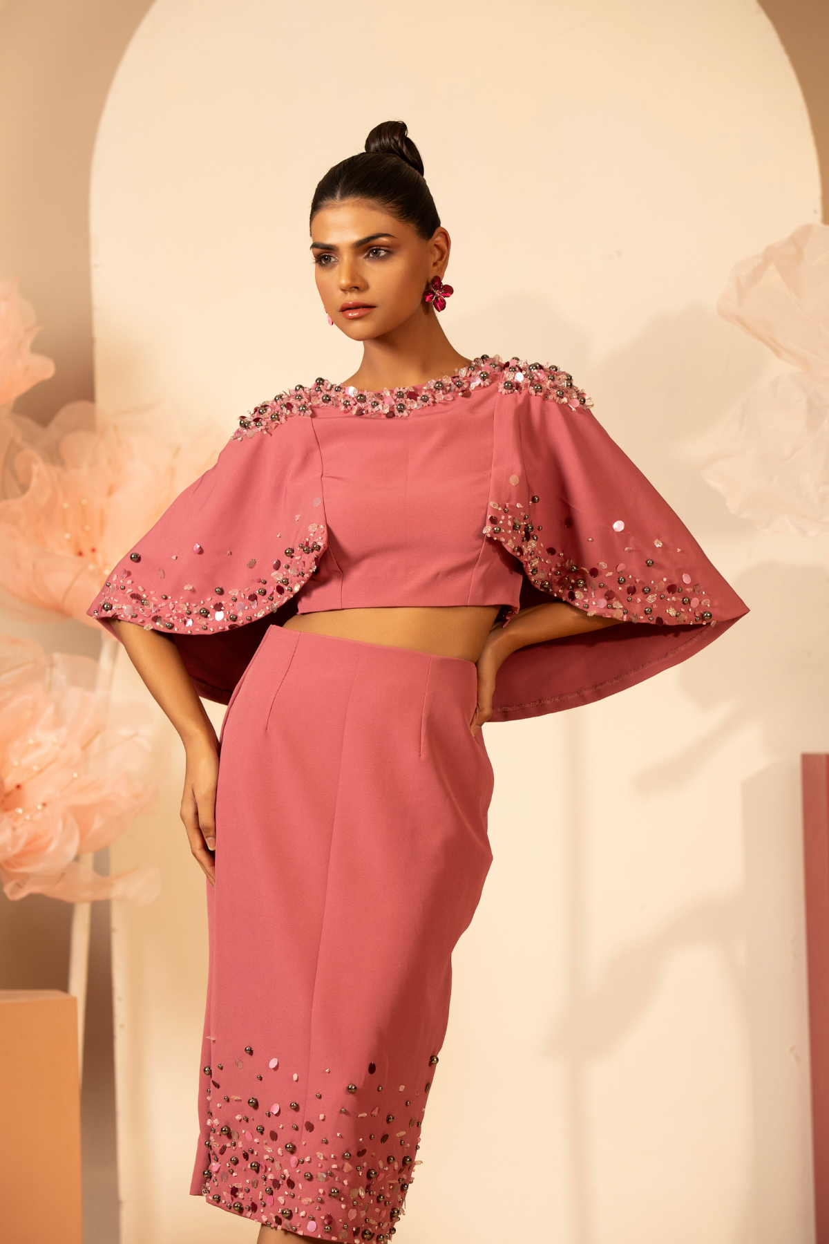 This elegant two piece contemporary set is embellished cape top the neckline and cape edges are heavily adorned with handcrafted 3D floral applique pearl sequins and pencil skirt matching hand embroidered Shop Now!