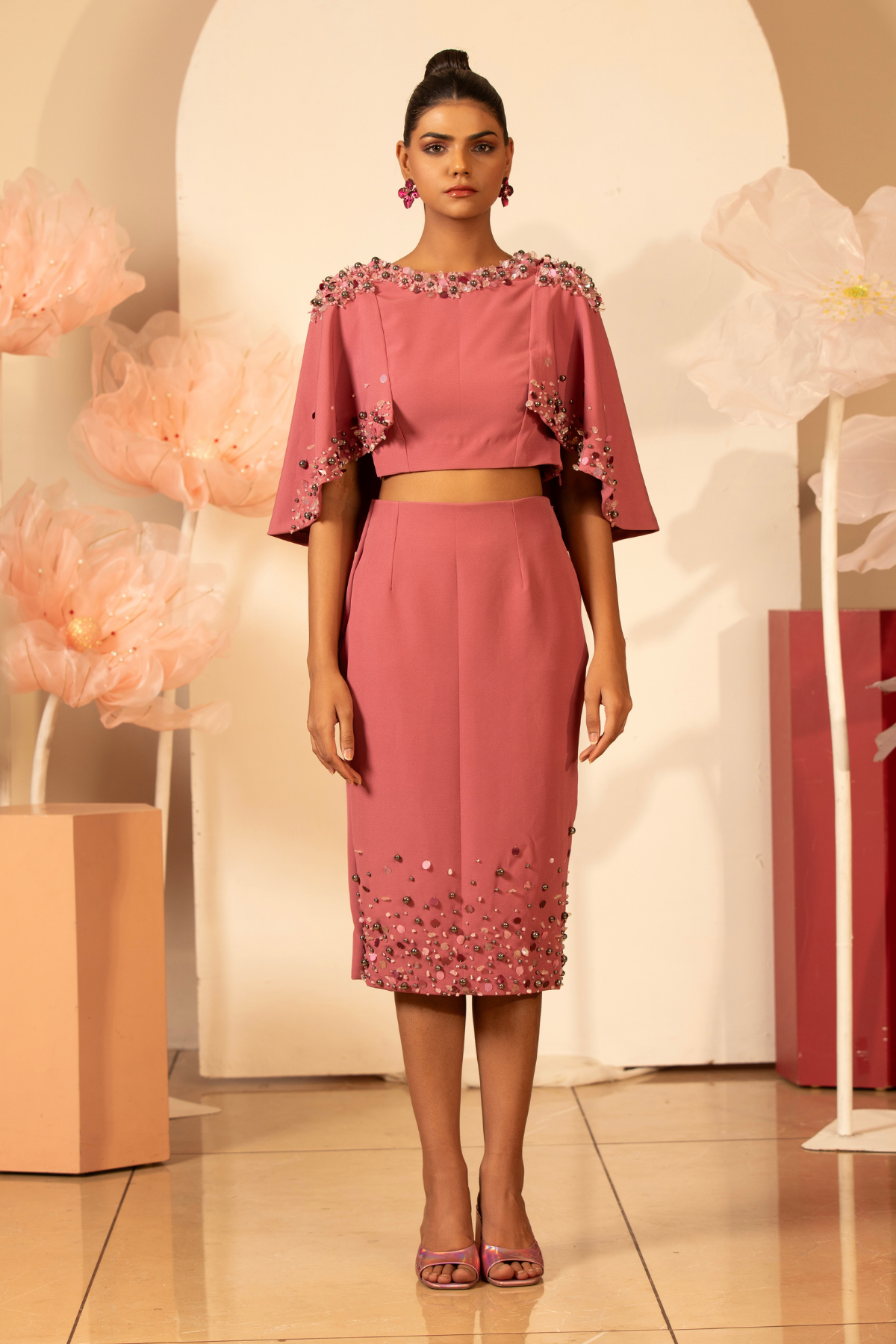 This elegant two piece contemporary set is embellished cape top the neckline and cape edges are heavily adorned with handcrafted 3D floral applique pearl sequins and pencil skirt matching hand embroidered Shop Now!
