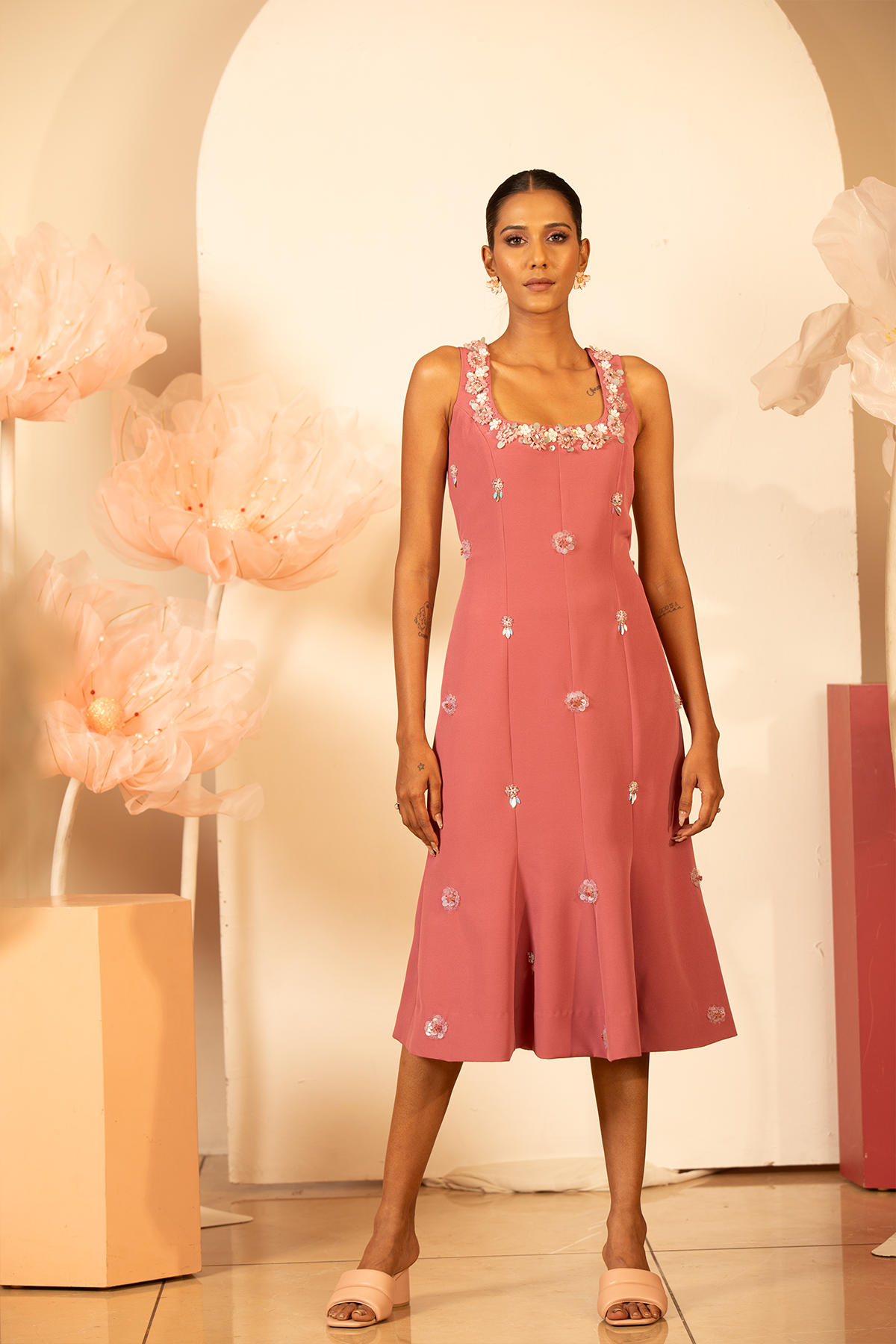 The dress is distinguished by intricate 3D applique embroidery concentrated around the neck line and scatterd across the body of the garment Shop Now!