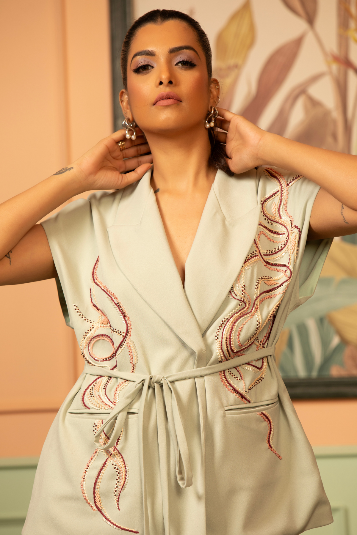 This sea green coord set artisanal tailoring details relaxed fit cal sleeve wrap top paired with fluid wide leg trousers tie up belt at waitline and embellishments dark dori threadwork lapels pocket Shop Now!