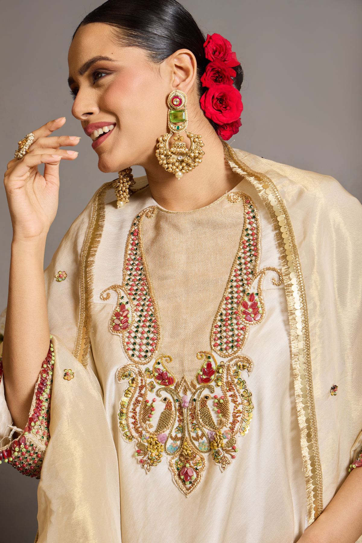 An elegant ivory kurta set crafted in a lustrous fabric, paired with tapered trousers and a fluid dupatta. Features exquisite multicolour handcrafted embroidery with ornate paisley-inspired motifs. A delicately embellished dupatta with gold edging and richly embroidered cuffs completes the look . Shop Now!