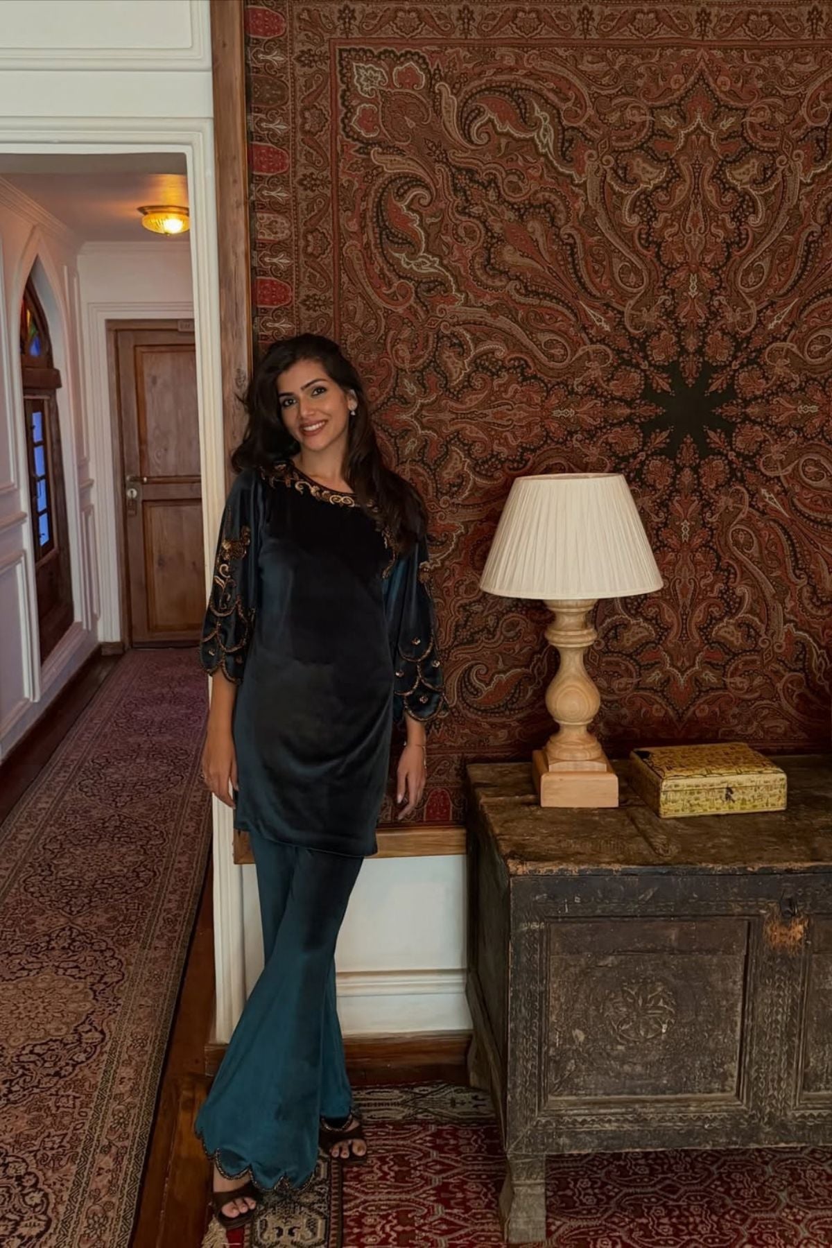 Bottle green velvet keyhole kurti with Baroque motif work, paired with scalloped trousers detailed on neckline, sleeves, and hem Shop Now!