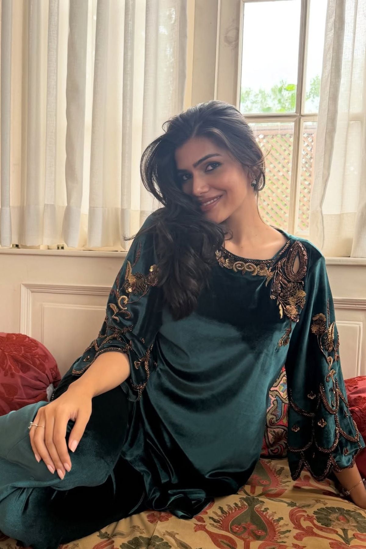 Bottle green velvet keyhole kurti with Baroque motif work, paired with scalloped trousers detailed on neckline, sleeves, and hem Shop Now!