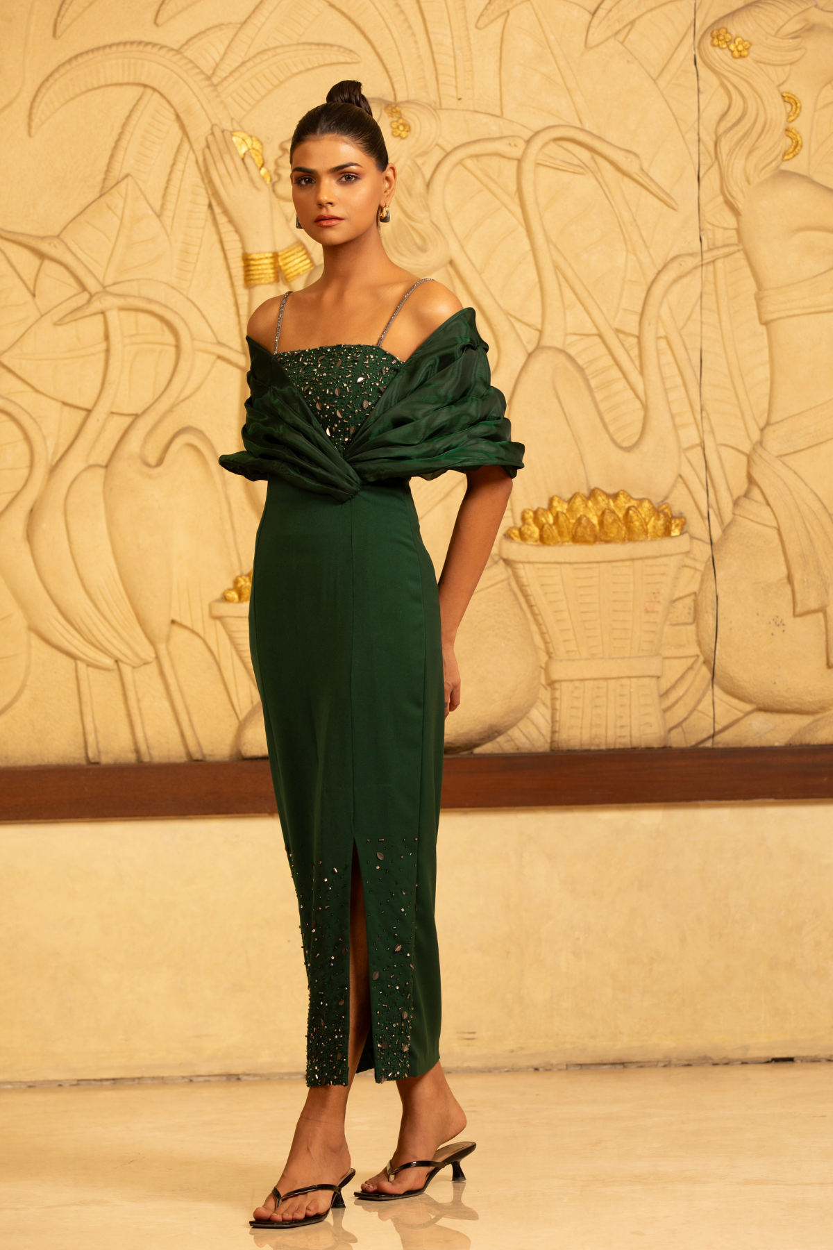 This emerald green evening gown distinctive  three piece texture combination with structured draping  strapeless neckline dedicated spaghetti straps the upper bustier ares is heavily qembellished with shimmering crystals sequins and beadwork Shop Now!
