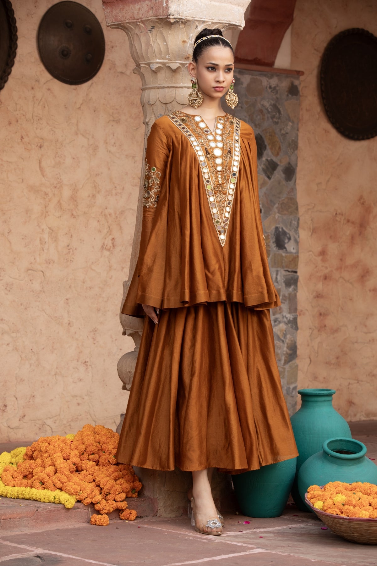 ure Chanderi silk kalidaar tunic with midi lehenga, intricately hand-embellished with zari and mirror work. Shop Now!