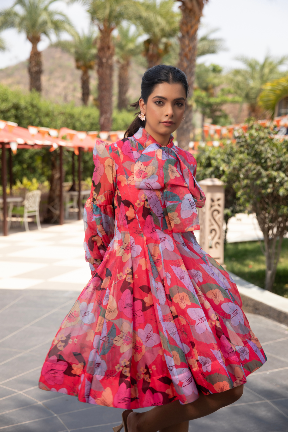 A floral inspired dress with vibrant  hibiscus colour and a bow accent  Shop Now!