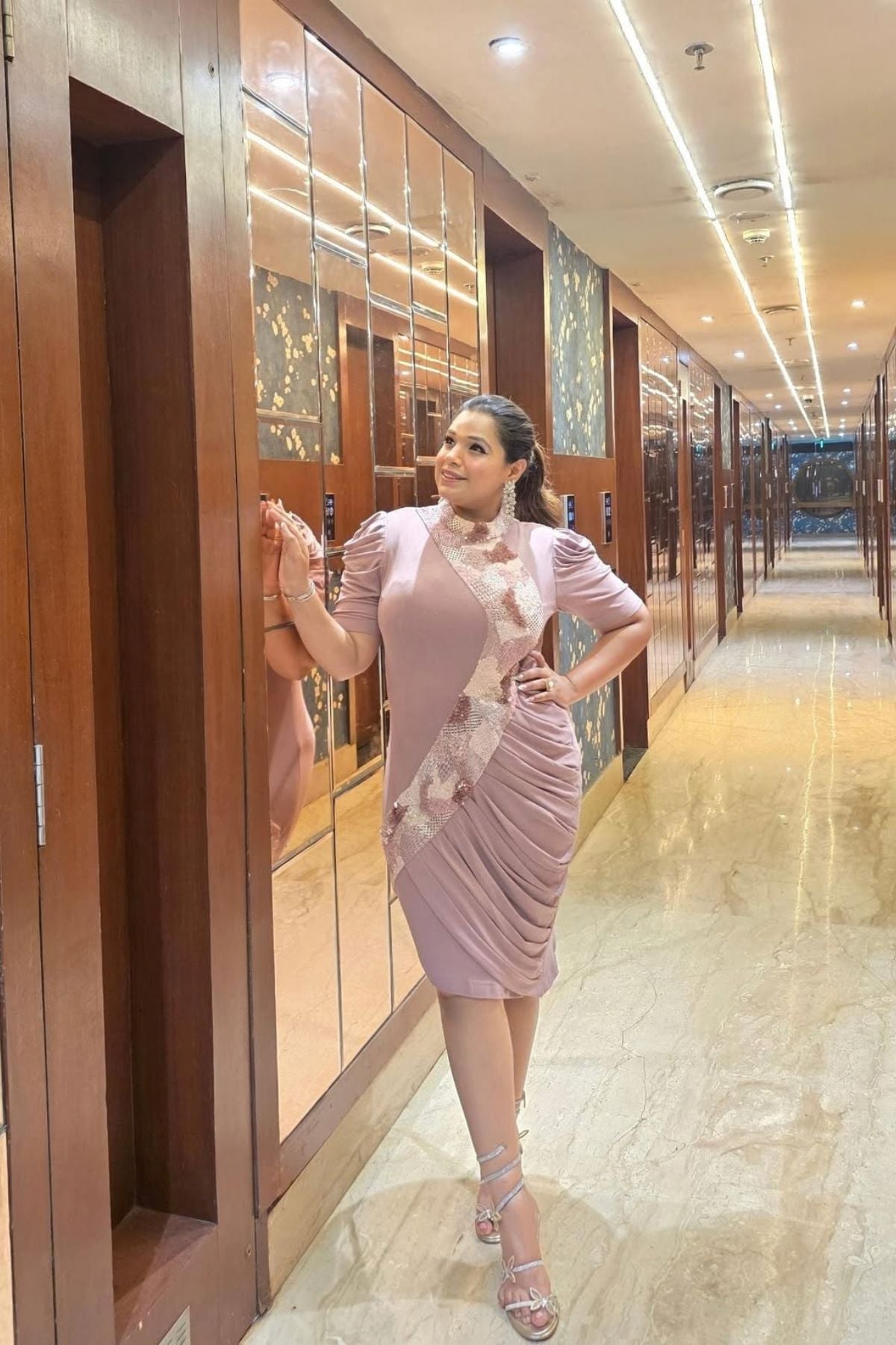 The dress is designed with a flattering&nbsp;form fitting bodycon include soft draping&nbsp;slightly stretchyhigh neck collar and structured&nbsp;puff sleeves shimmering multi tone sequins&nbsp;that flow from neckline to down across. Shop Now!