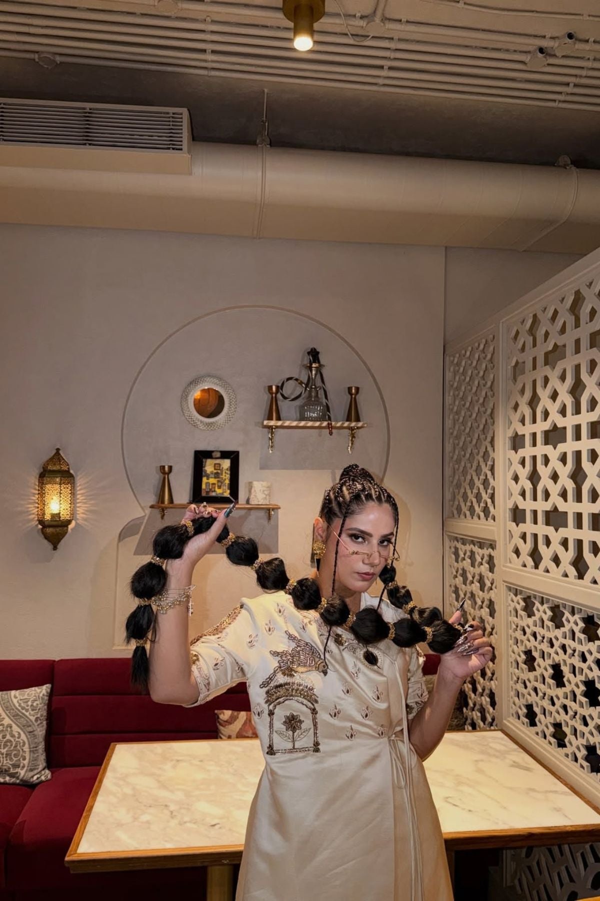 Ivory linen tissue satin angrakha with birdcage motif, paired with a tissue zari drape. Shop Now!