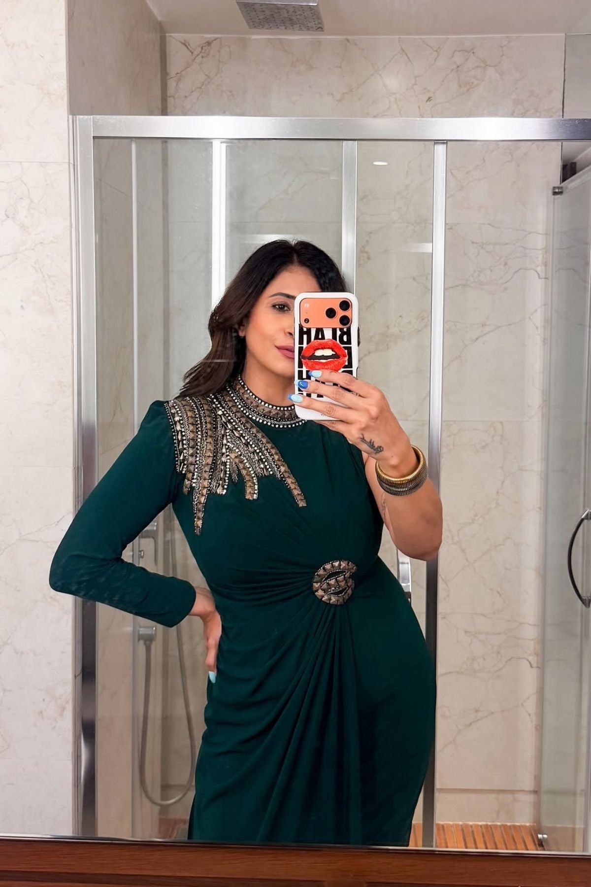 Asymmetric gown deep emerald green&nbsp;hue blending morder tailoring with intricate&nbsp;traditional embellishment fitted waist and&nbsp;a fluid draped faux wrap skirt at the midsection. Shop Now!