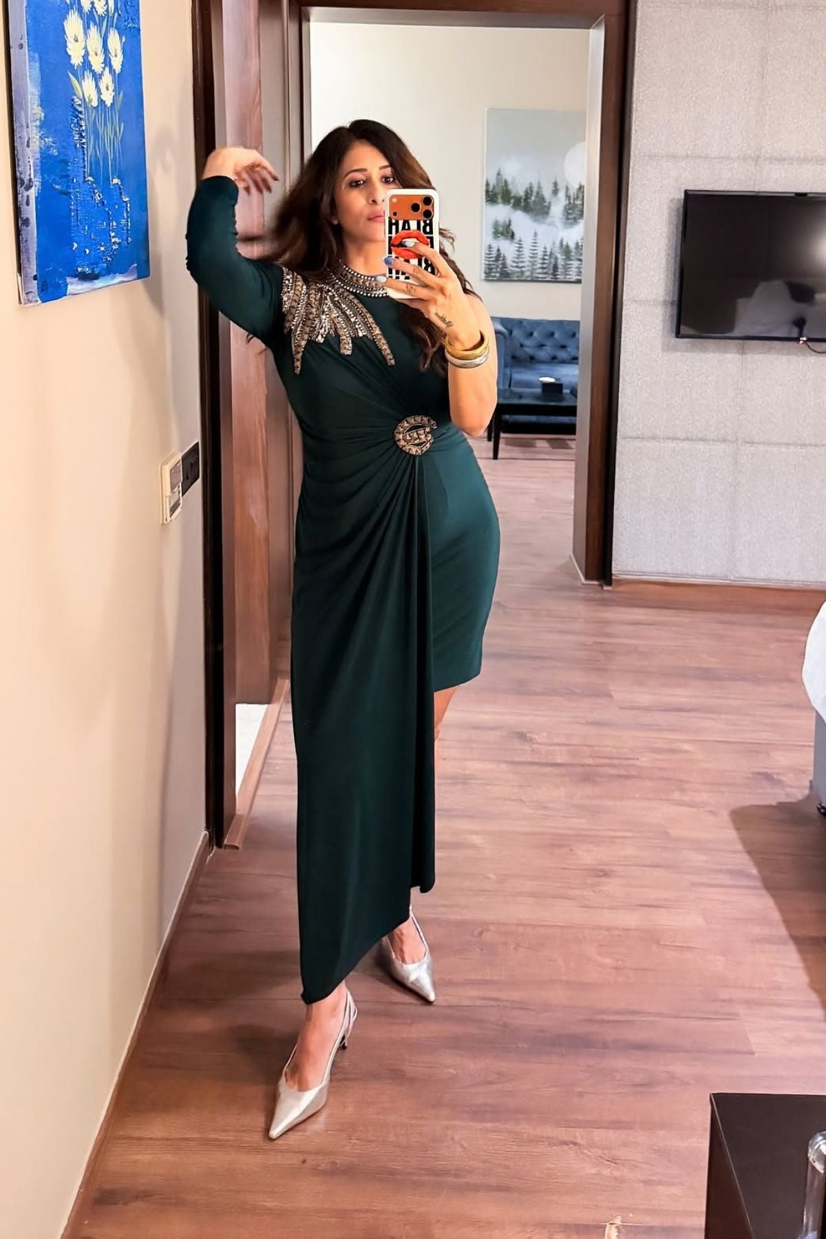 Asymmetric gown deep emerald green&nbsp;hue blending morder tailoring with intricate&nbsp;traditional embellishment fitted waist and&nbsp;a fluid draped faux wrap skirt at the midsection. Shop Now!