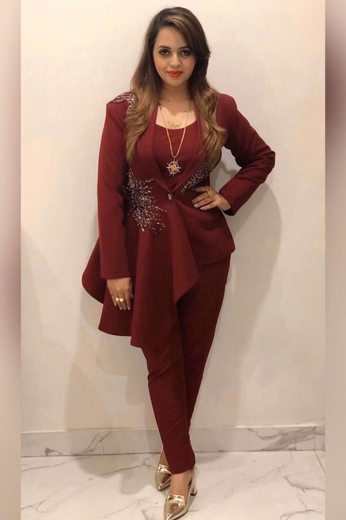 Tailored to sartorial perfection this single-breasted roll collar, peplum style blazer is paired with classic trousers. Its artistic intricate hand-embroidery with a mix of pipes, beads, sequin,cutdana, etc reflects aesthetic craftsmanship . Shop Now!