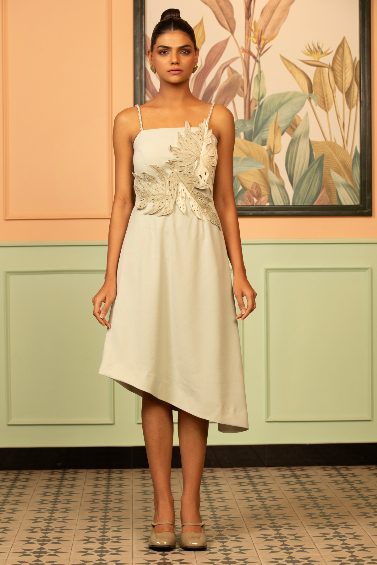 This off white dress features a distinctive 3D floral and leaf applique on the bodice giving botanical garden inspired A line with asymmetric hemline that is shorter  on one side square neckline spaghetti straps  Shop Now!