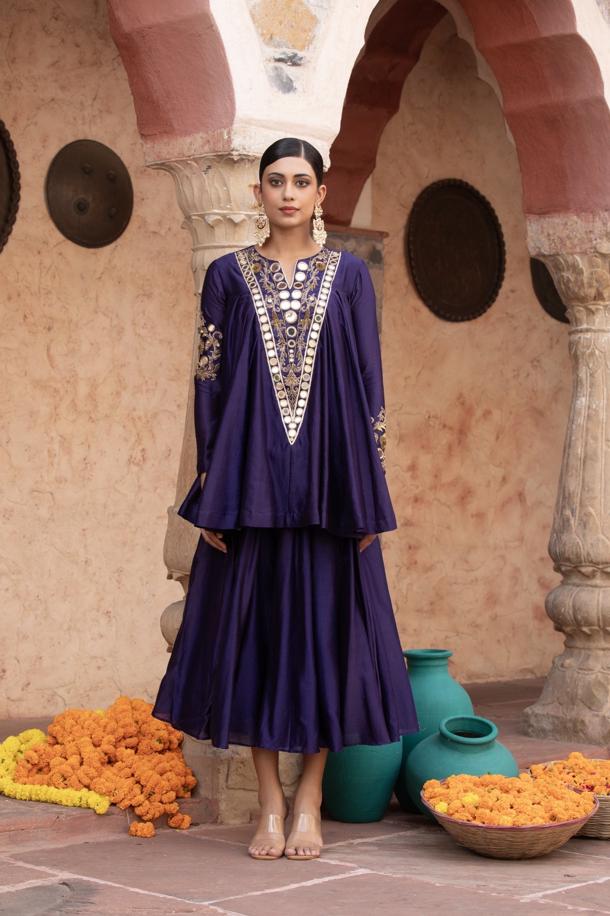 Pure Chanderi silk full-sleeve kalidaar tunic with midi lehenga, intricately hand-embellished with zari and mirror work. Shop Now!