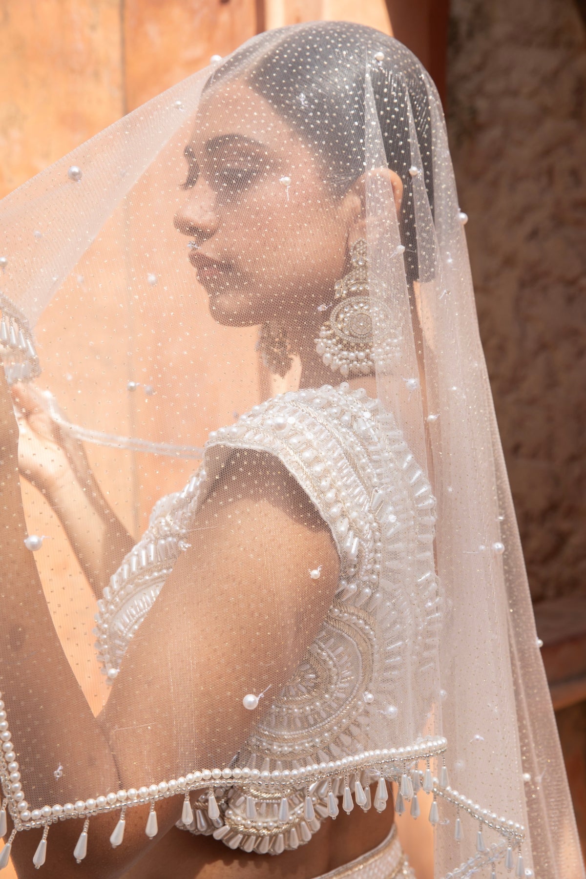 Ivory metallic foil net lehenga with pearl beadwork and scalloped detailing — perfect for bridesmaids. Shop Now!