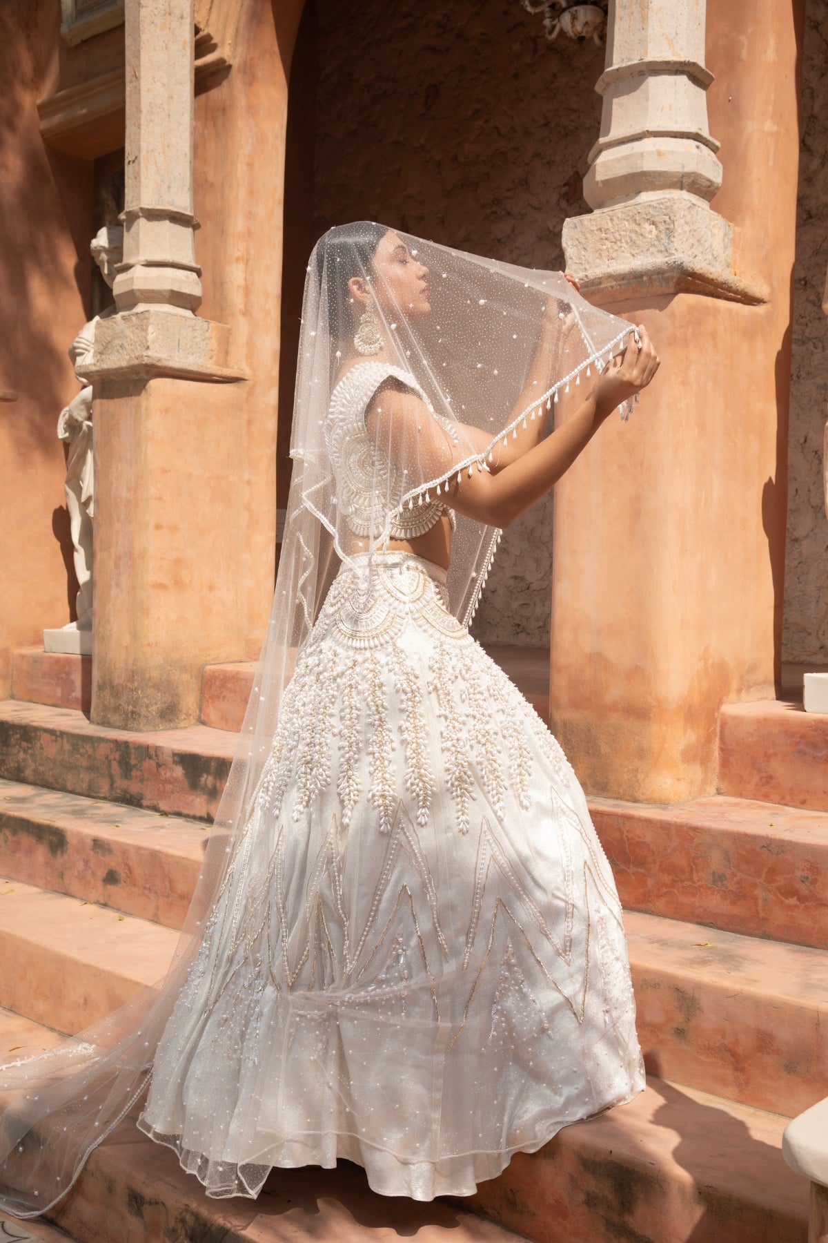Ivory metallic foil net lehenga with pearl beadwork and scalloped detailing — perfect for bridesmaids. Shop Now!