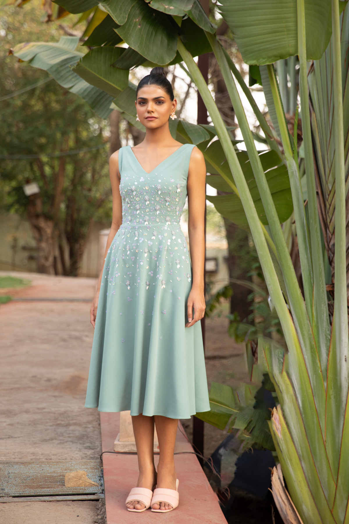 A line sleeveless midi dress in soft mint v neck line paired with fitted bodice tonal floral embroidery Shop Now!