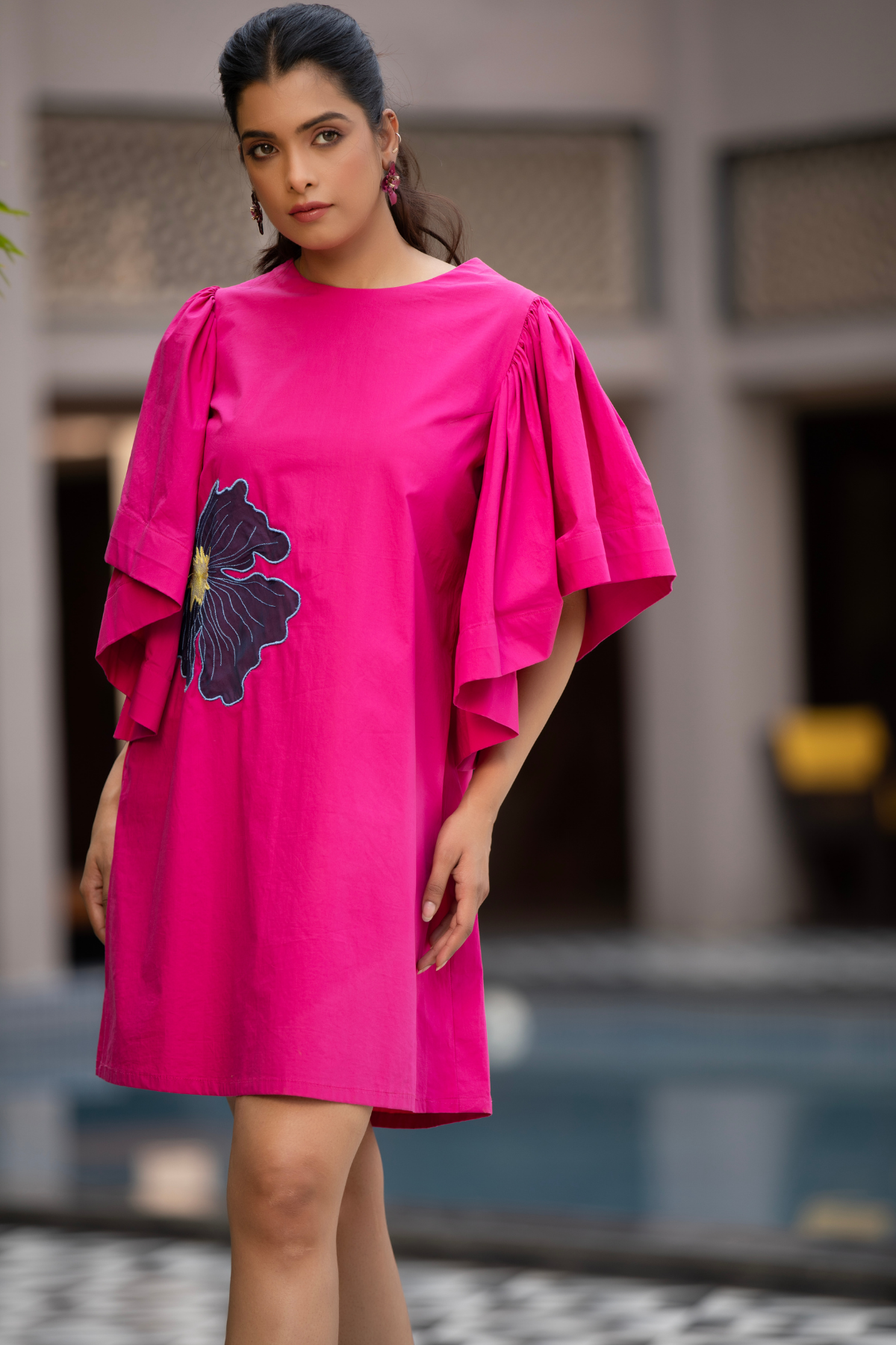 This vibrant fuchsia pink mini dress is characterized by its bold silhouette and striking artistic details Shop Now!