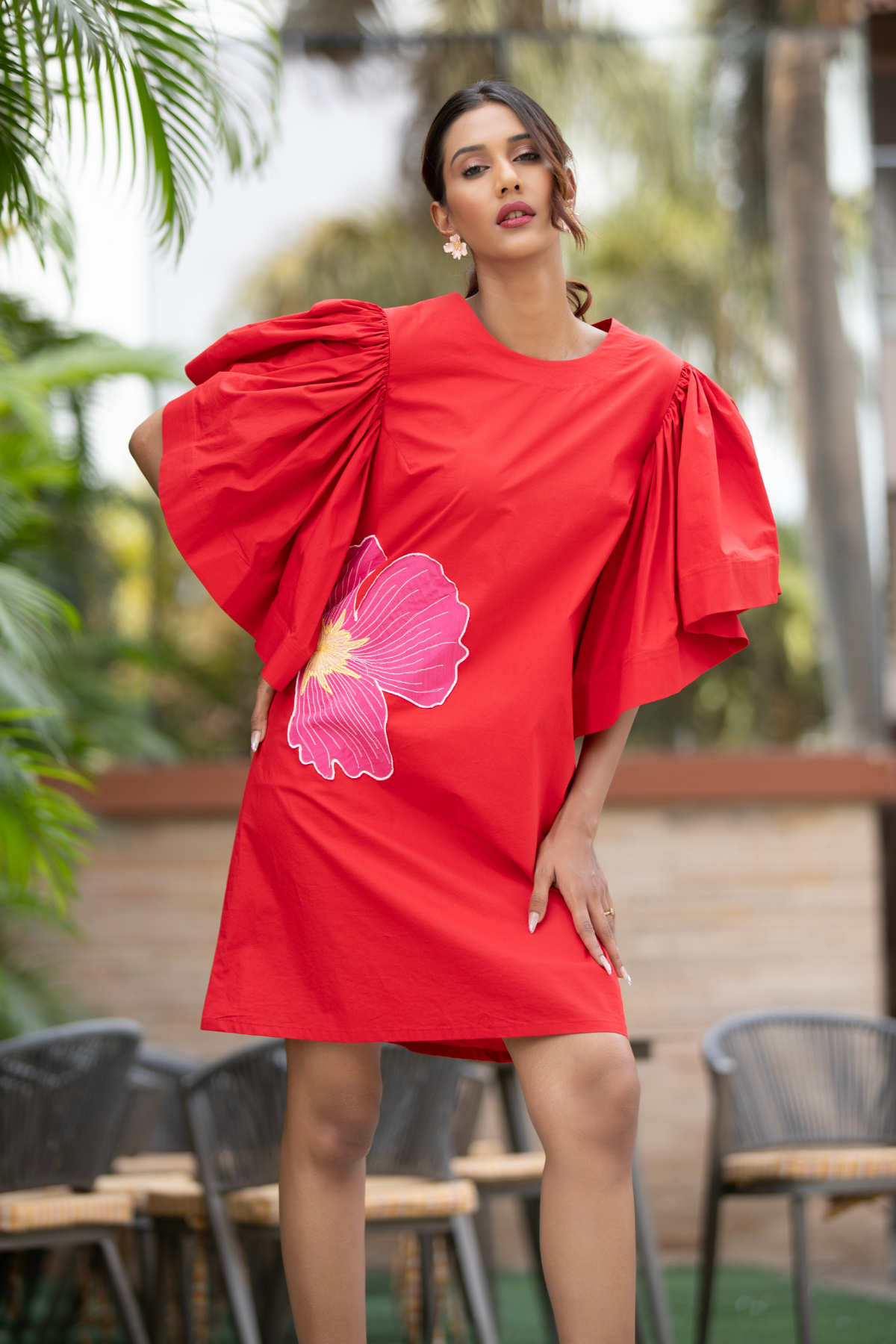 The dress is a vibrant red shift mini dress balance as relaxed fit and bold architectural details Shop Now!