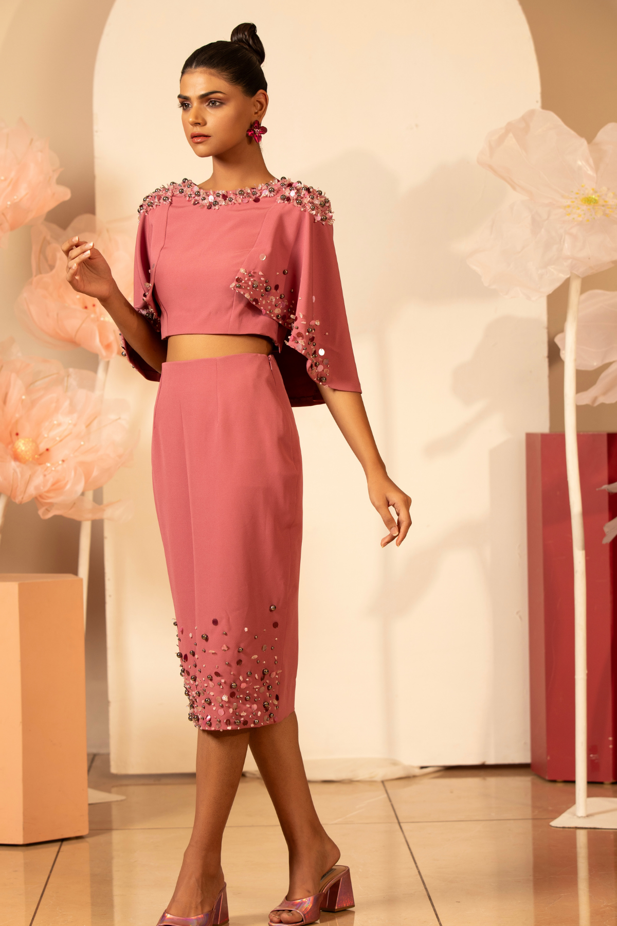 This elegant two piece contemporary set is embellished cape top the neckline and cape edges are heavily adorned with handcrafted 3D floral applique pearl sequins and pencil skirt matching hand embroidered Shop Now!