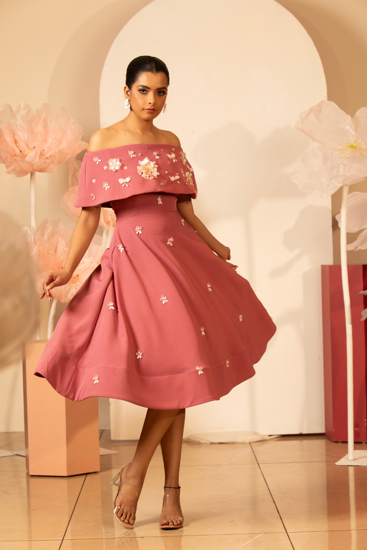 The off  the shoulder dress which delicate three dimentional floral applique and flower motif  with light handed detailing sequins and bead.Fit and flare falls to a mid calf length  Shop Now!