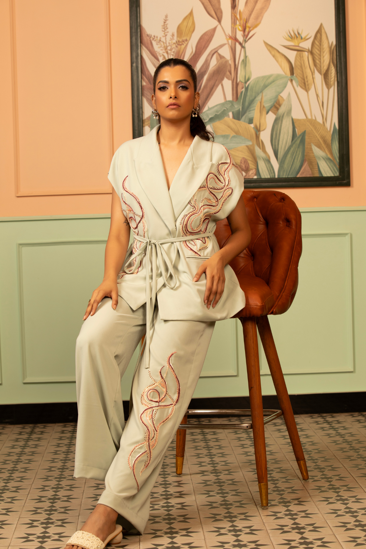 This sea green coord set artisanal tailoring details relaxed fit cal sleeve wrap top paired with fluid wide leg trousers tie up belt at waitline and embellishments dark dori threadwork lapels pocket Shop Now!