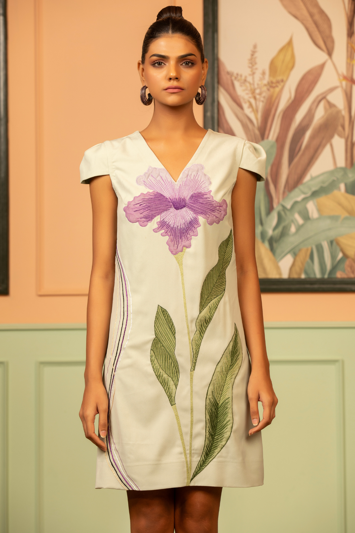 The dress is an 3D orchid applique in shade of purple with long green leaves , v neck line with handkerchief cut Shop Now!