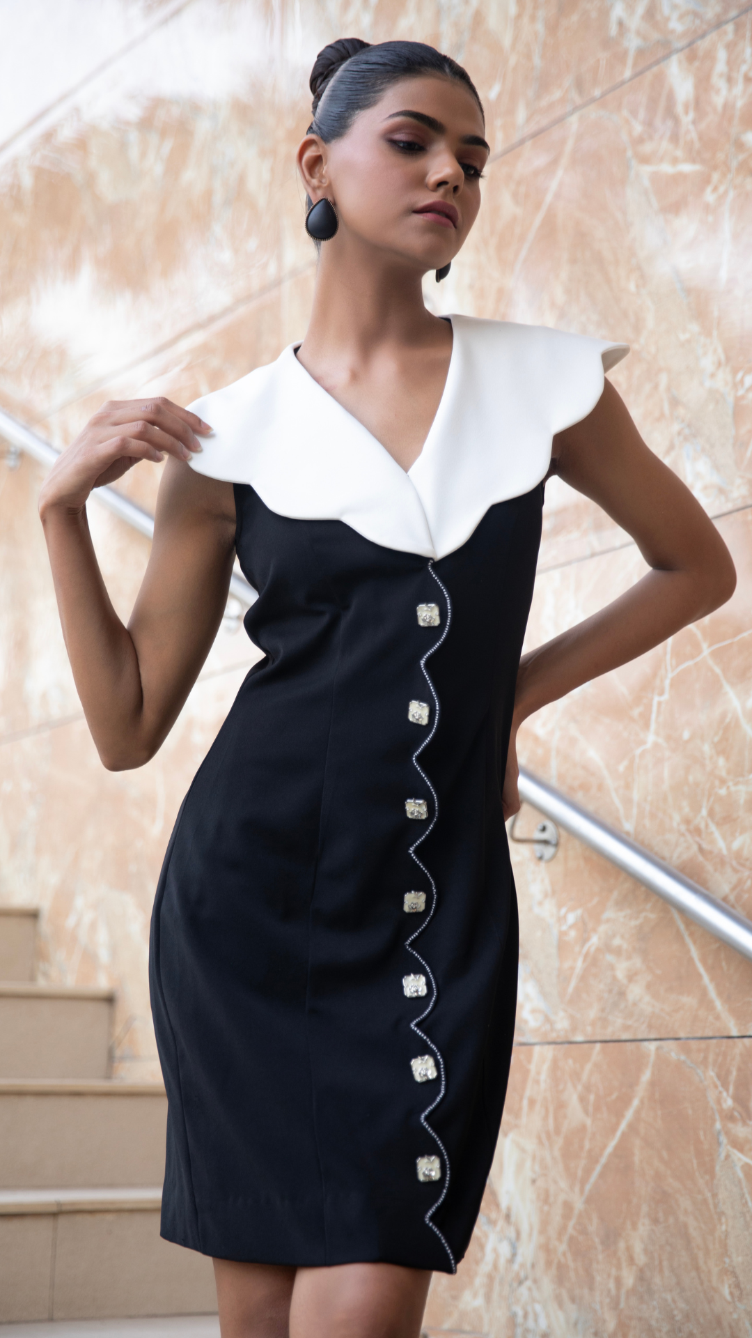 Black and white a line dress featuring a statement scalloped white collar and  elegant front button  Shop Now!