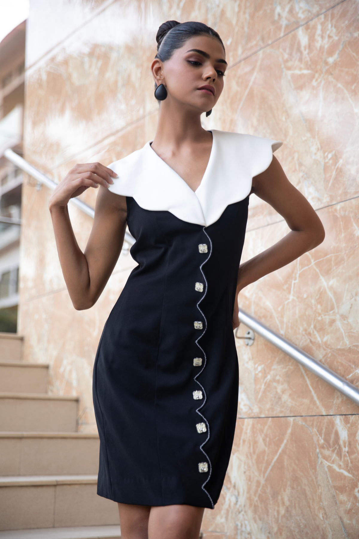 Black and white a line dress featuring a statement scalloped white collar and elegant front button Shop Now!