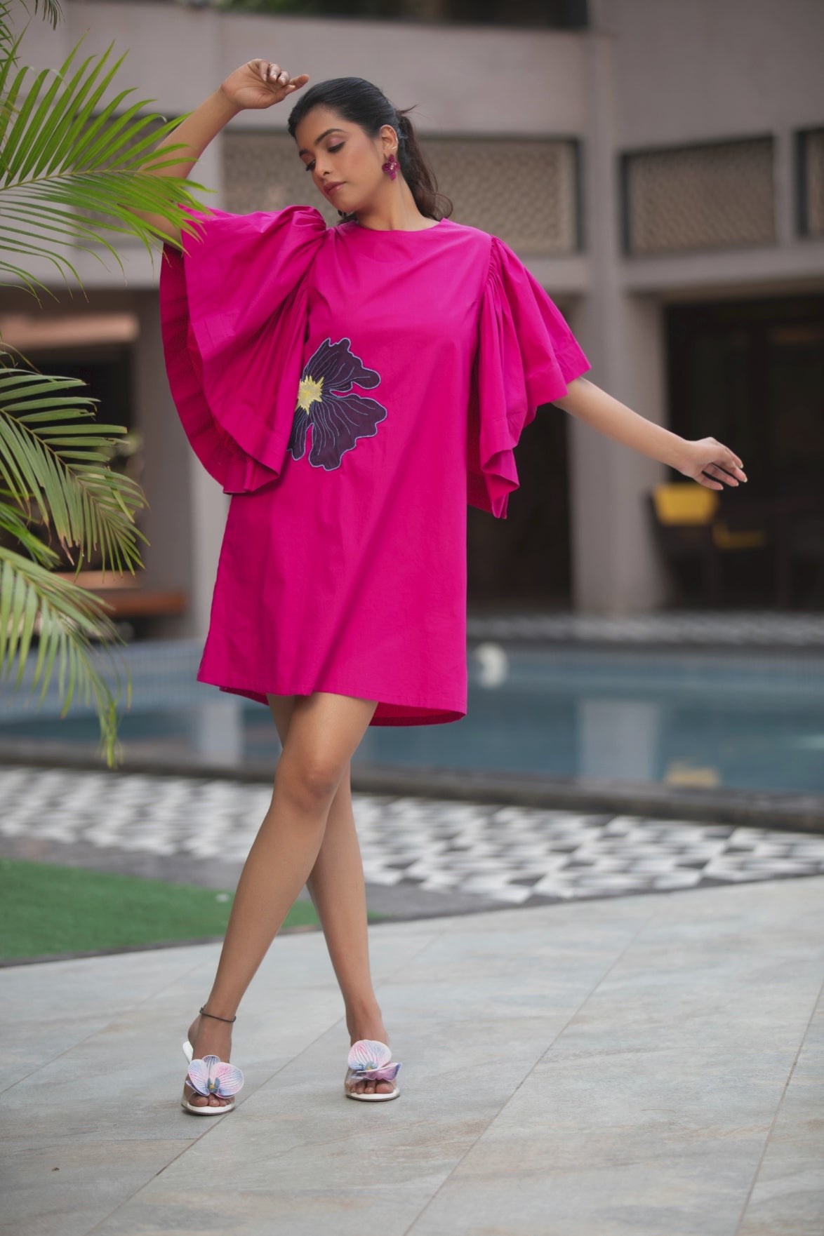 This vibrant fuchsia pink mini dress is characterized by its bold silhouette and striking artistic details Shop Now!