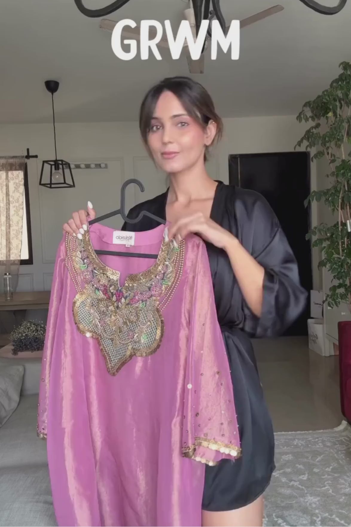 A luminous rose-pink kurta and flared palazzo set crafted in rich,metallic-finish fabric. Featuring an ornate multicolour embroidered neckline with intricate zardozi inspired detailing. Paired with a contrasting deep-blue dupatta finished with elegant gold borders. A festive ensemble that beautifully blends contemporary ease with traditional opulence. Shop Now!