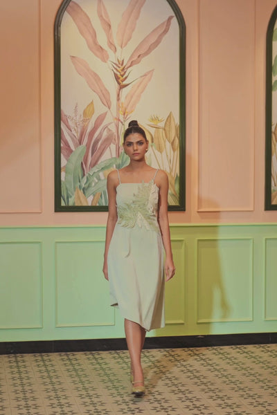 This off white dress features a distinctive 3D floral and leaf applique on the bodice giving botanical garden inspired A line with asymmetric hemline that is shorter  on one side square neckline spaghetti straps  Shop Now!
