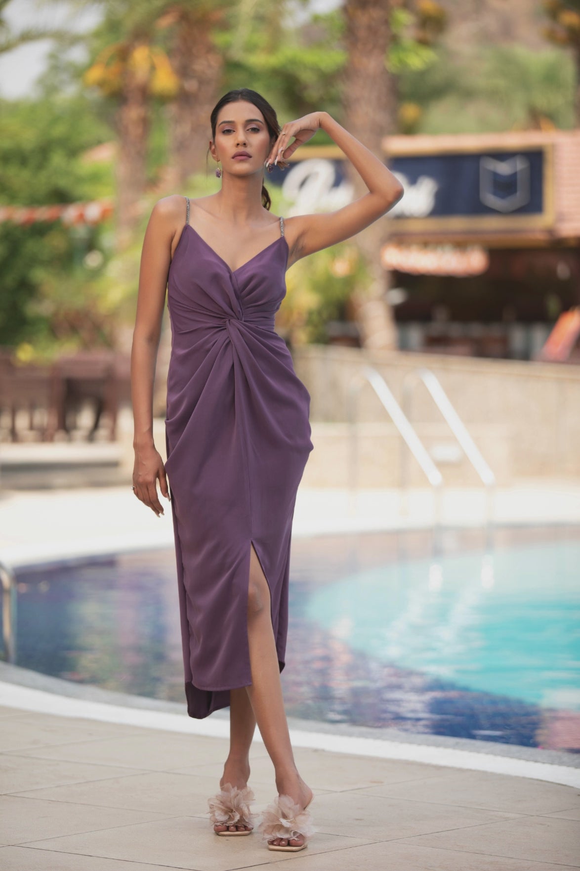 An elegant purple midi evening dress highlighted by its front wrap detail Shop Now!