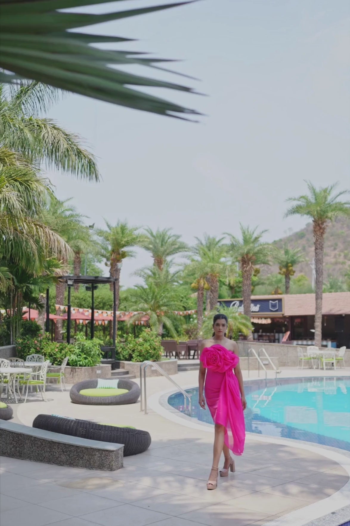 A graceful drape dress in a vibrant  hot pink hue featuring silhouette Shop Now!