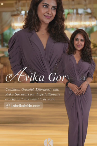 This dress is a purple ankle length embellished drape dress with abstract work hand pleating and draping at waist neckline notched lapel collar with adeep v neckline and  structured sleeve  Shop Now!