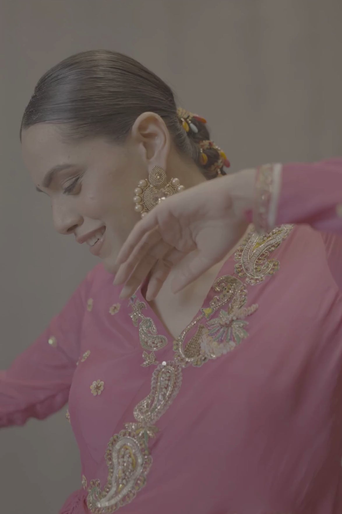 A striking fuchsia-pink Anarkali in a fluid lustrous fabric, designed with an elegant layered flare. Intricate paisley and floral embroidery in multicoloured threadwork enhances the neckline and waist. Handcrafted statement tassels adds festive charm. A vibrant contemporary Silhoutte perfect for festive soirées. Shop Now!